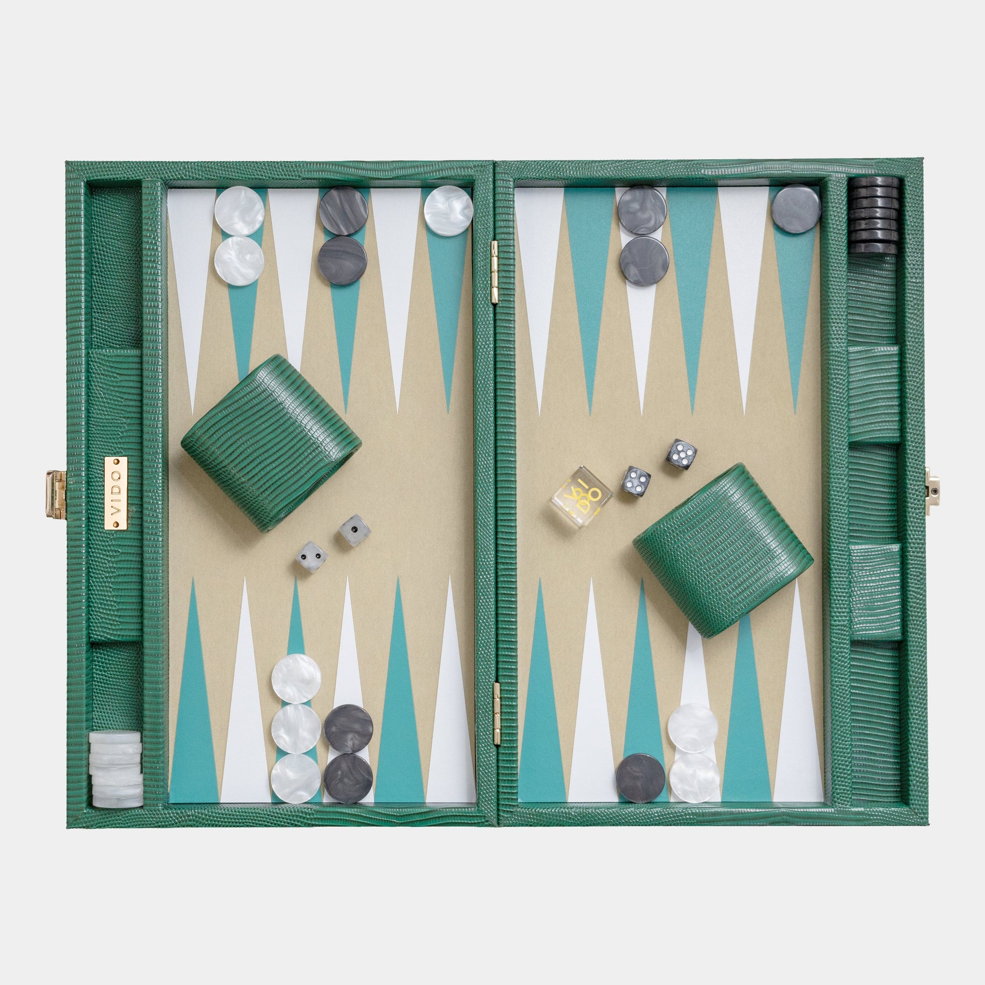 Backgammon set with green board and pieces on a white background by VIDO