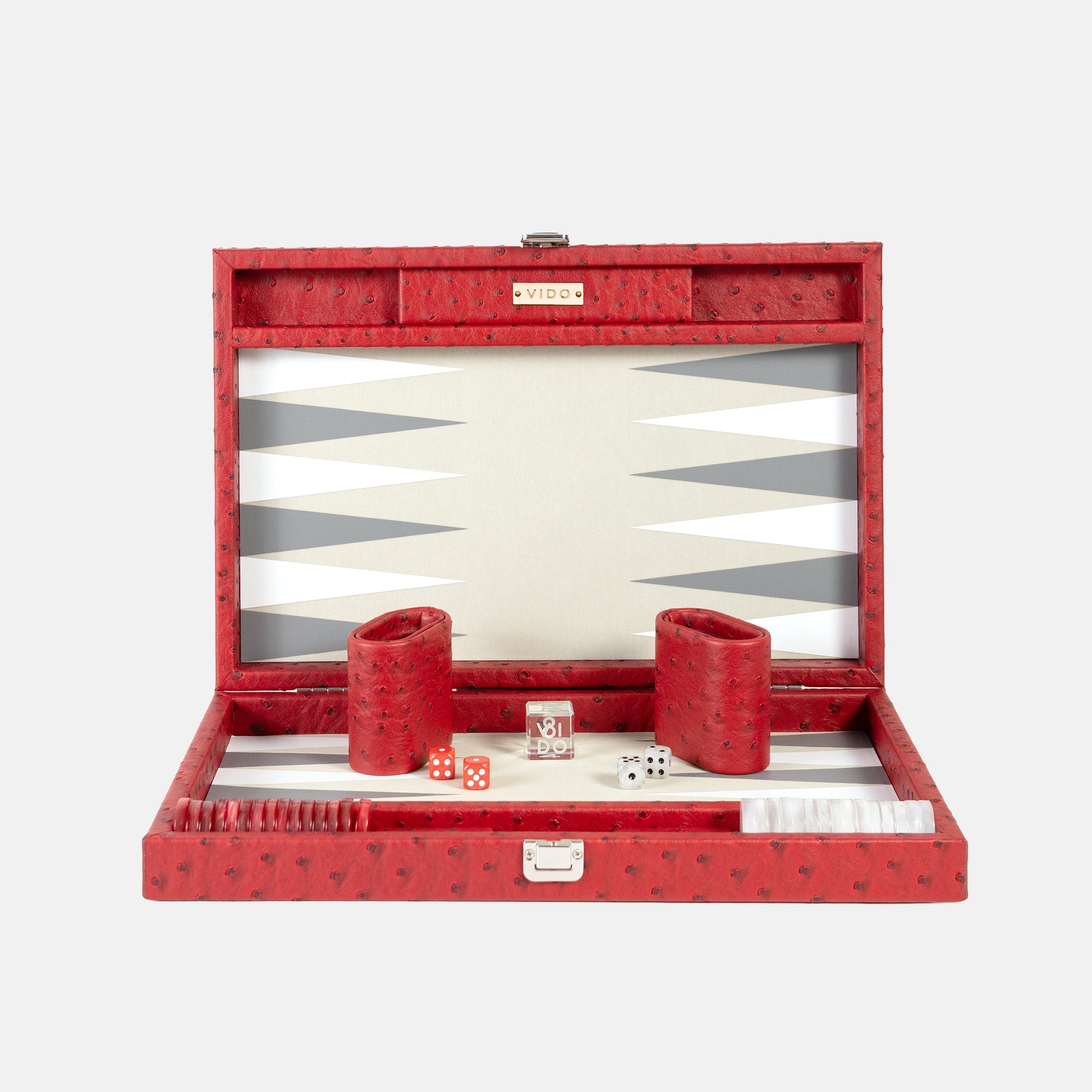 Red backgammon set with pieces and dice on a white background by VIDO
