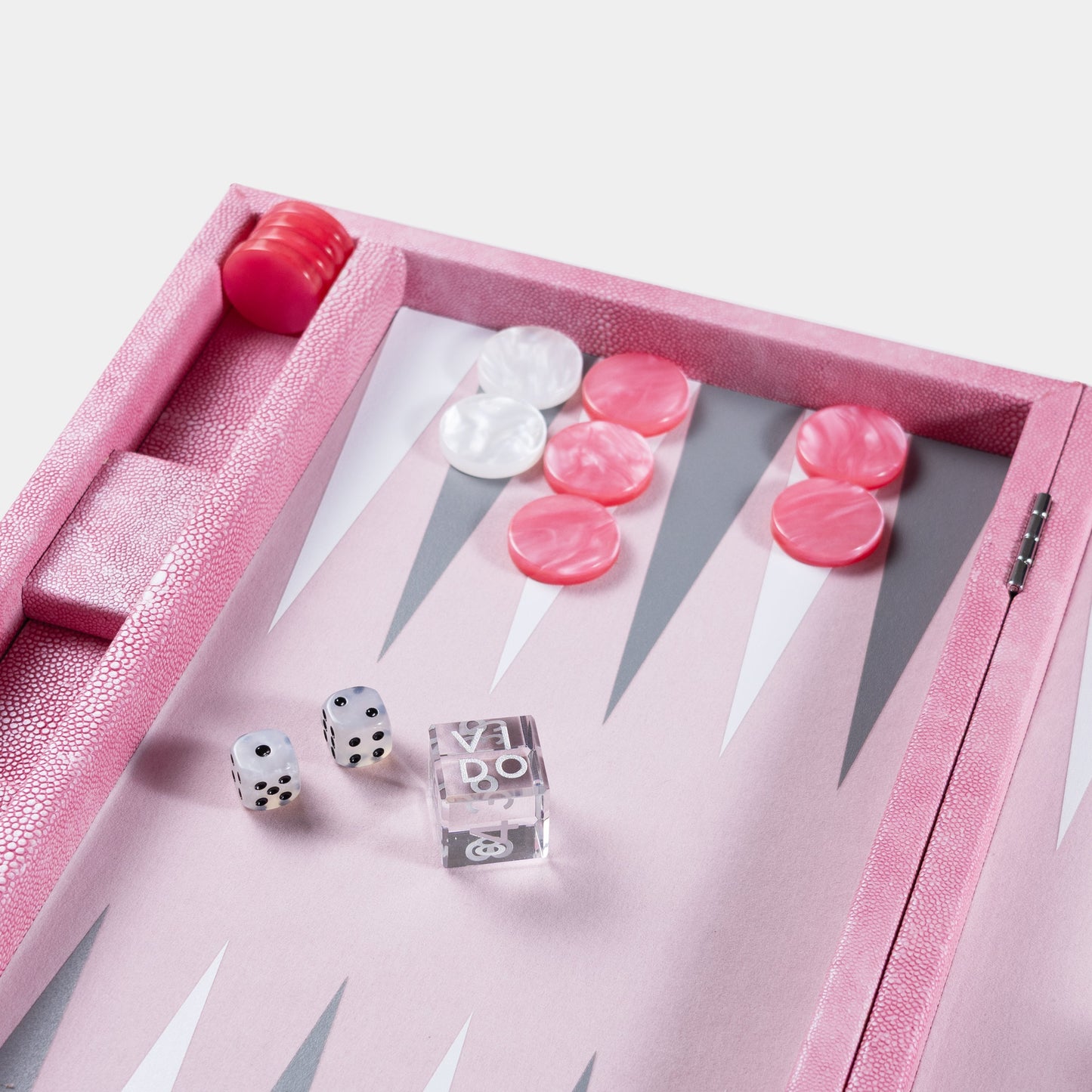 Pink backgammon set with dice on a light gray background focus by VIDO
