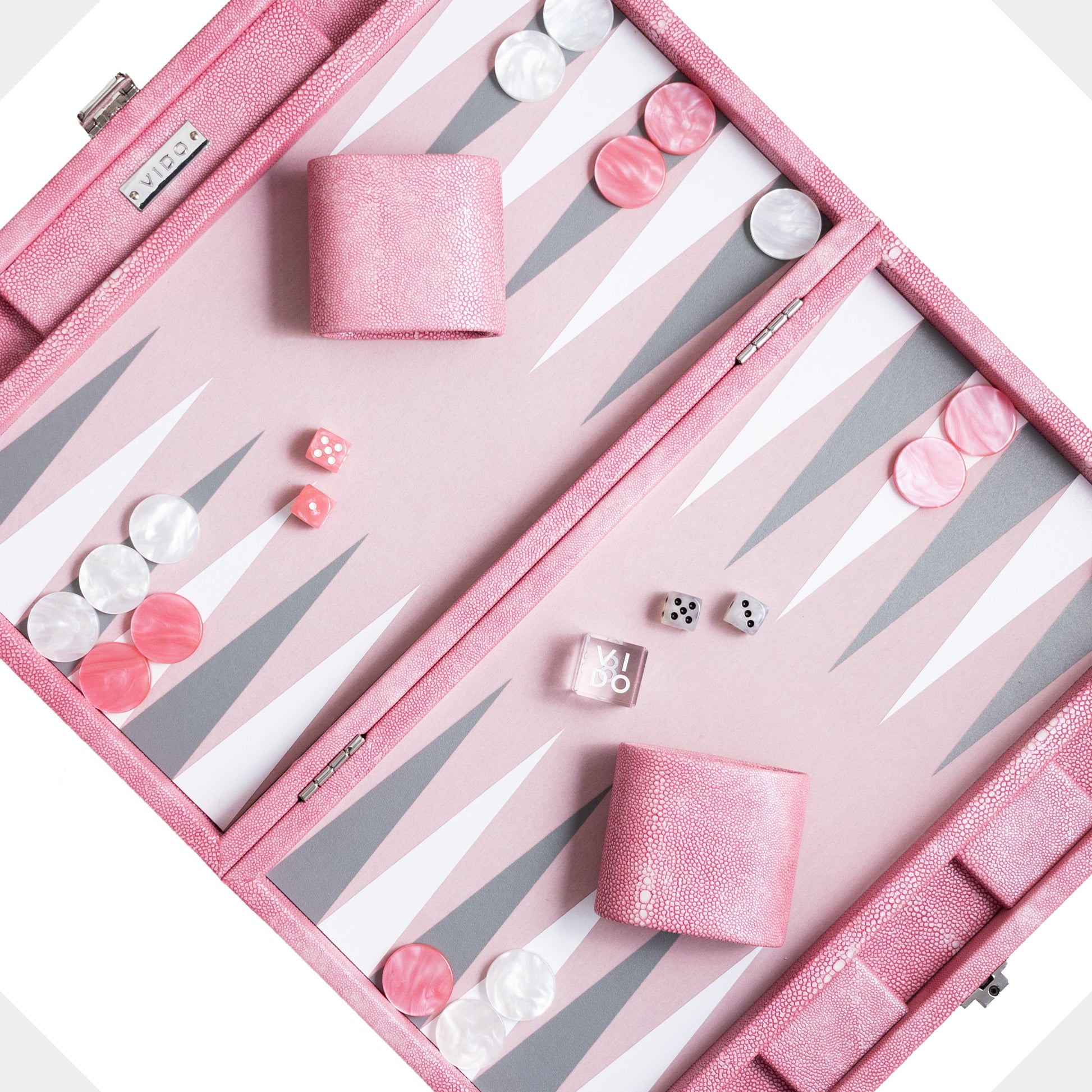 Pink backgammon set with pieces and dice on a white background by VIDO