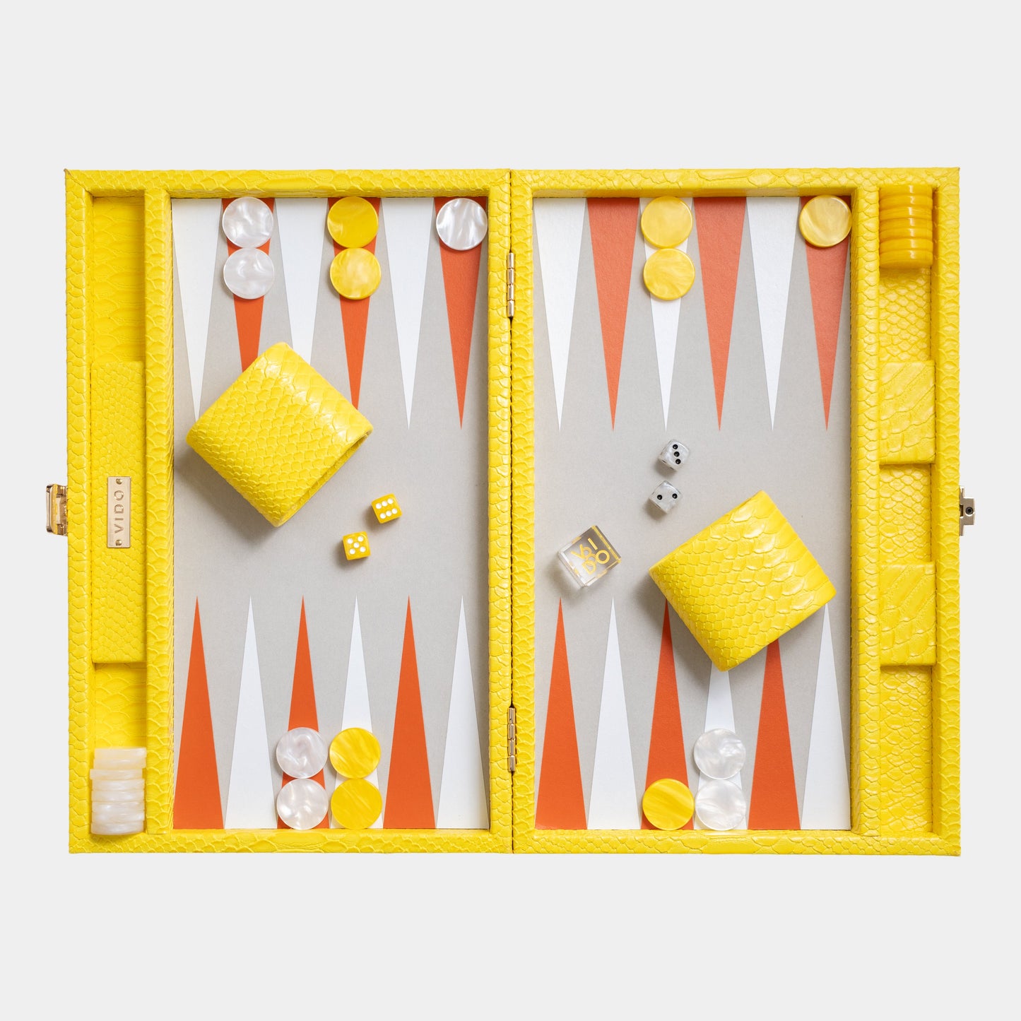 Backgammon set with yellow pieces and red and white points on a light gray background by VIDO